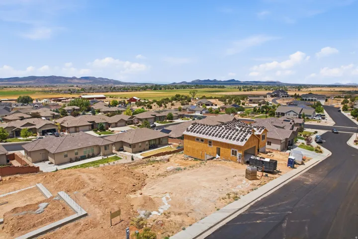 New construction property featuring framed exterior walls, a partially shingled roof, and an adjacent paved street