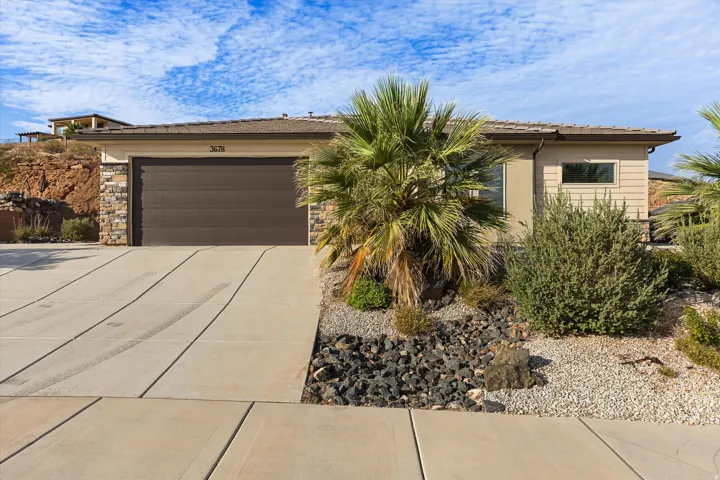 Contemporary single-story residence with a stone veneer and stucco exterior