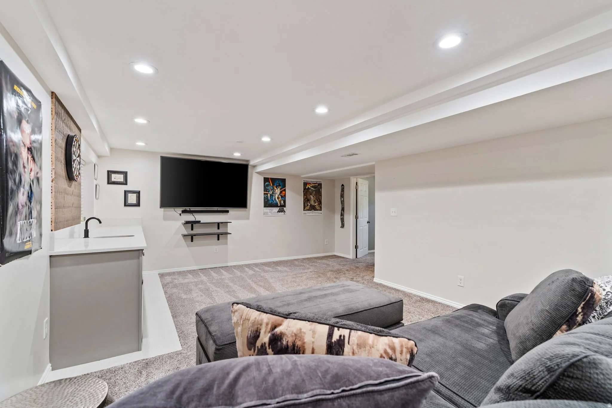 Finished basement with recessed lighting and neutral-toned carpeting