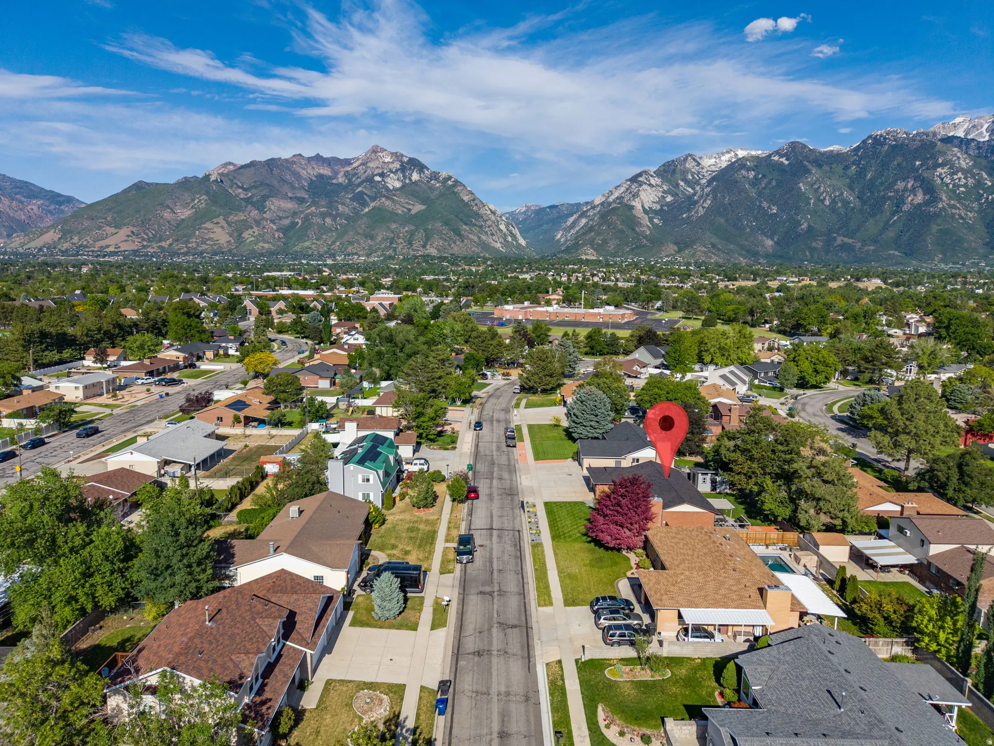 Aerial perspective showcasing a residential property with a partial swimming pool and mature landscaping