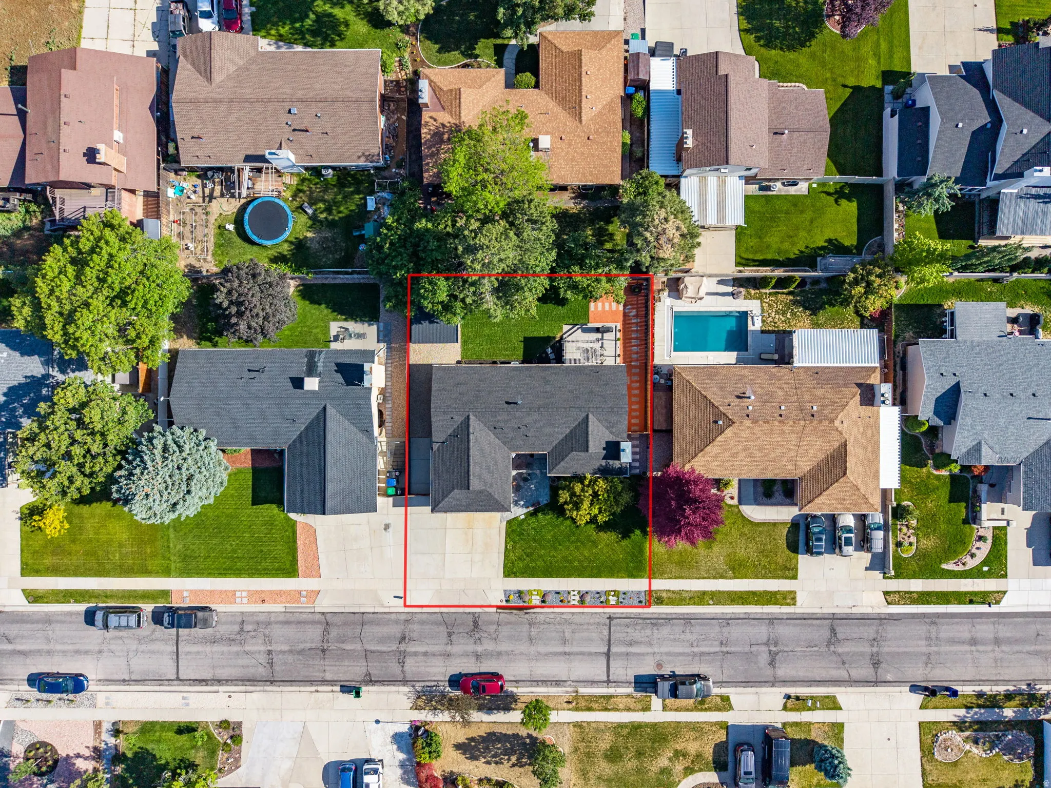 Aerial perspective showcasing a property with mature landscaping and a well-maintained backyard