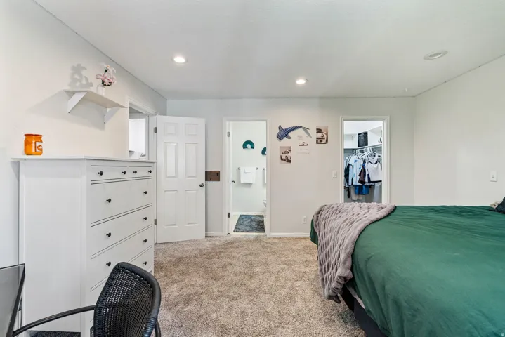 Carpeted interior space featuring white walls and recessed ceiling lighting