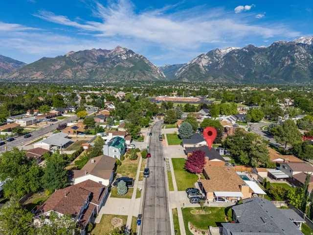 Aerial perspective showcasing a residential property with a partial swimming pool and mature landscaping