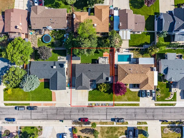 Aerial perspective showcasing a property with mature landscaping and a well-maintained backyard