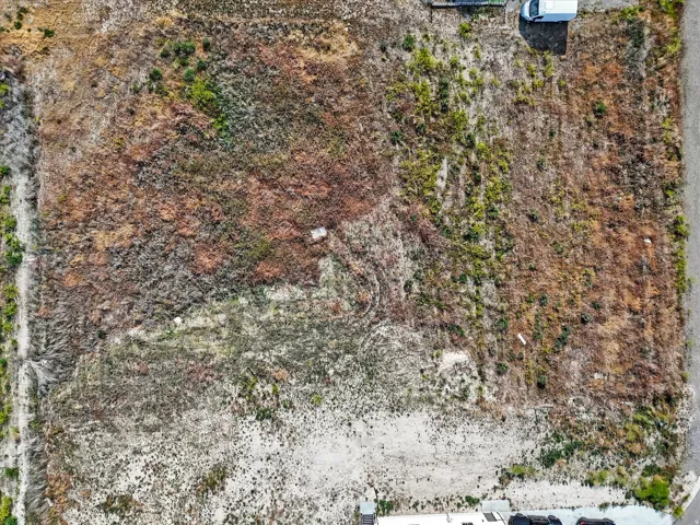 Expansive undeveloped parcel featuring varied ground cover and a discernible perimeter