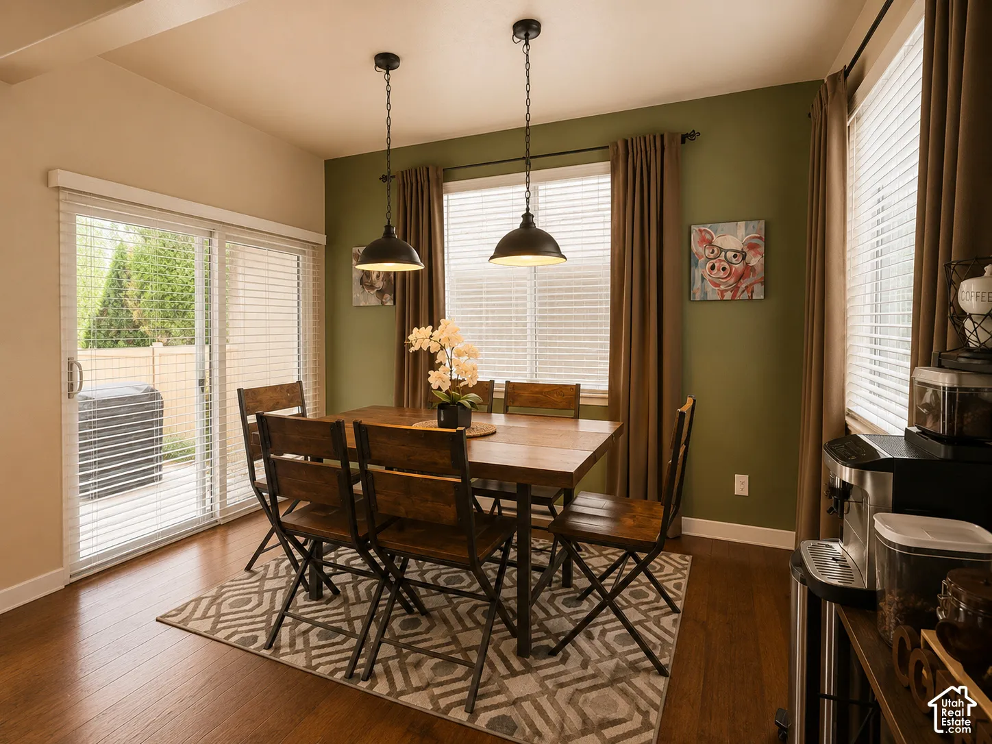 Dining area featuring warm wood-finish flooring and a sliding glass door to the exterior