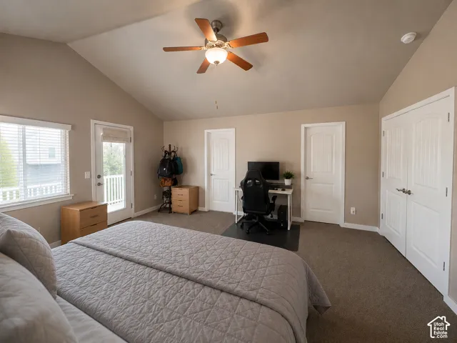 Carpeted room featuring a vaulted ceiling and a ceiling fan with integrated lighting