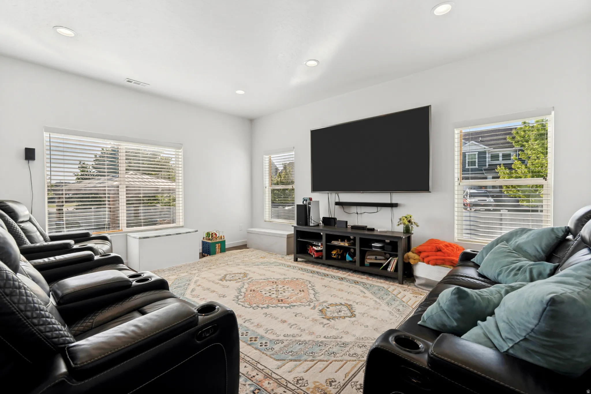 Bright living space featuring recessed lighting and white walls