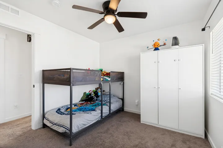 Neutral-toned carpeted flooring with white baseboards