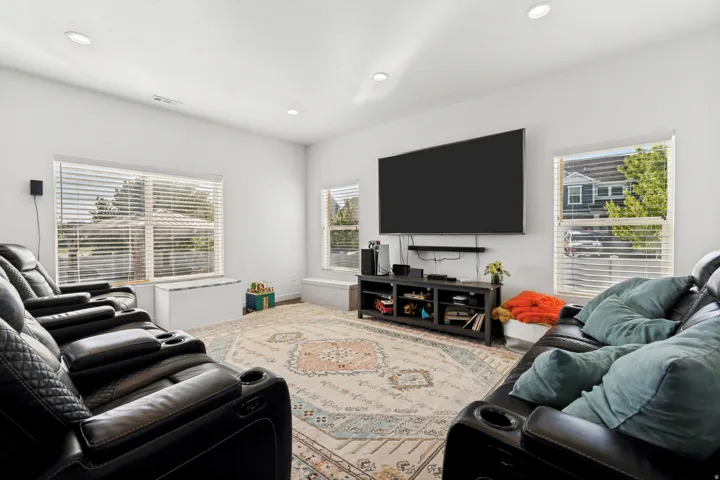 Bright living space featuring recessed lighting and white walls