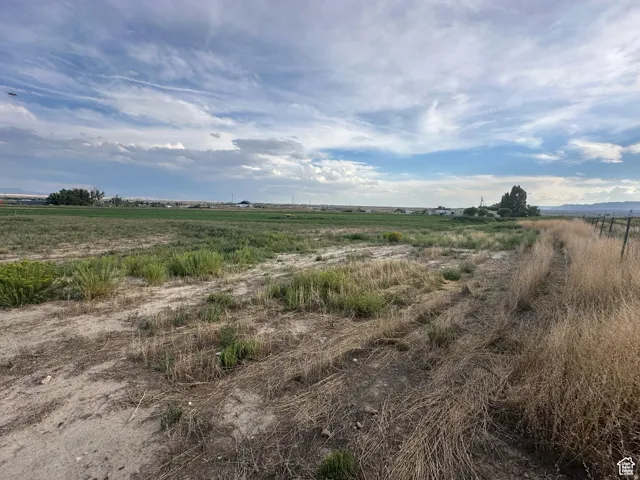 Expansive agricultural land featuring a partial perimeter fence