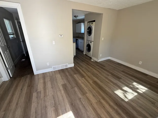 Open common area featuring wood-finish flooring, light neutral wall paint, and white trim