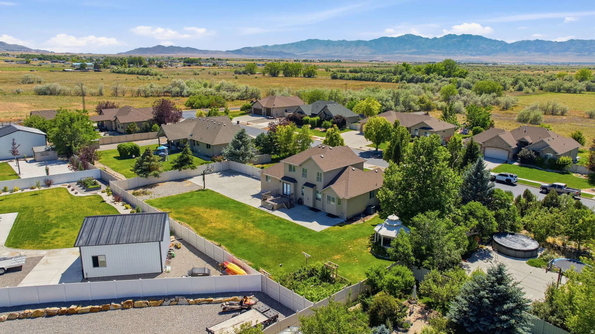 Aerial perspective showcasing a residential neighborhood with distant mountain ranges