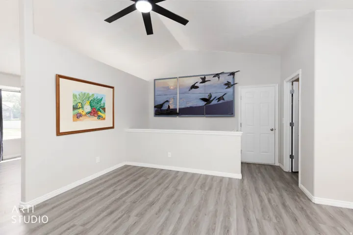 Vaulted ceiling with a black ceiling fan
