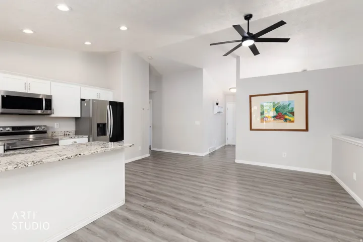 Open-concept living area with wood-finish flooring
