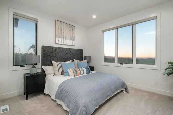 Spacious room featuring multiple large windows, recessed lighting, and soft carpet flooring
