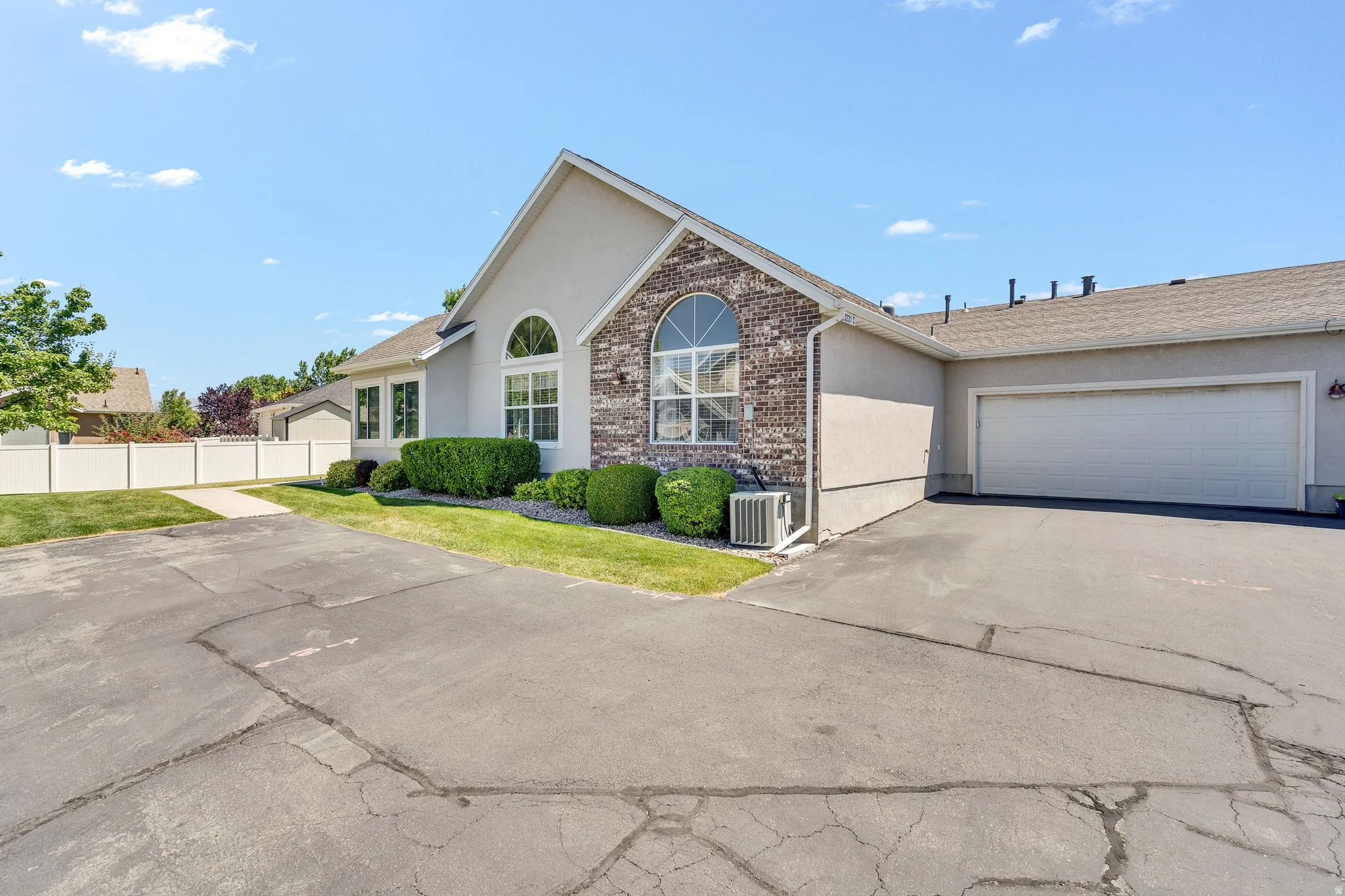 Stucco exterior with brick accenting and arched window features