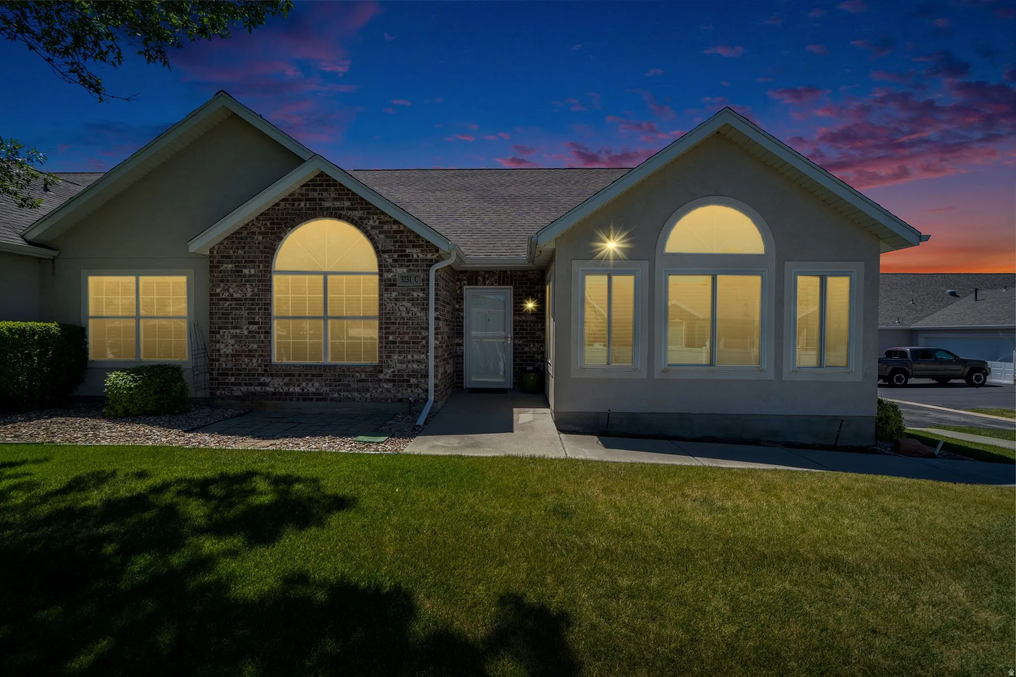 Exterior featuring a combination of brick and stucco finishes