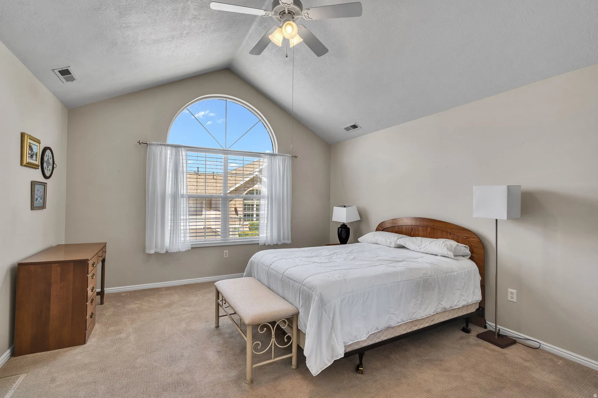 Primary Bedroom with Vaulted ceilings featuring a ceiling fan with integrated lighting
