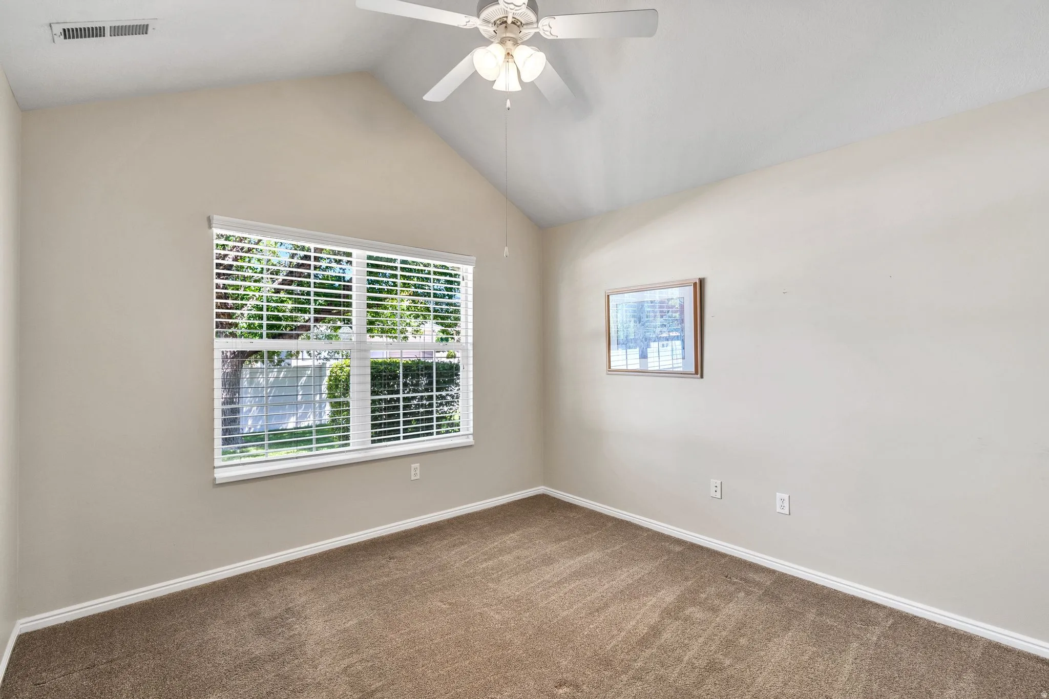 Second Bedroom featuring a vaulted ceiling and a ceiling fan with light fixture