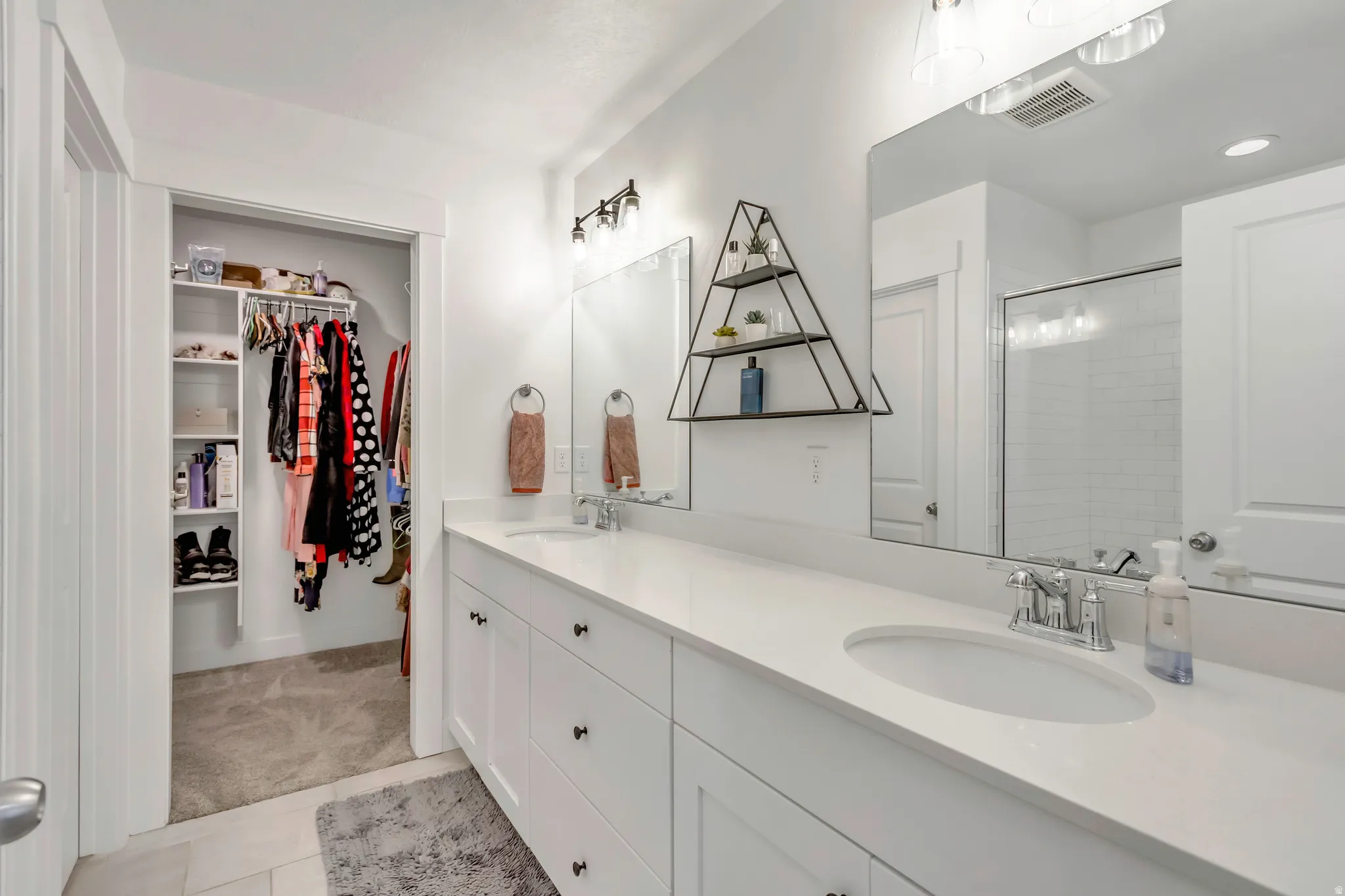 Double vanity with integrated sinks, chrome fixtures, and a spacious countertop