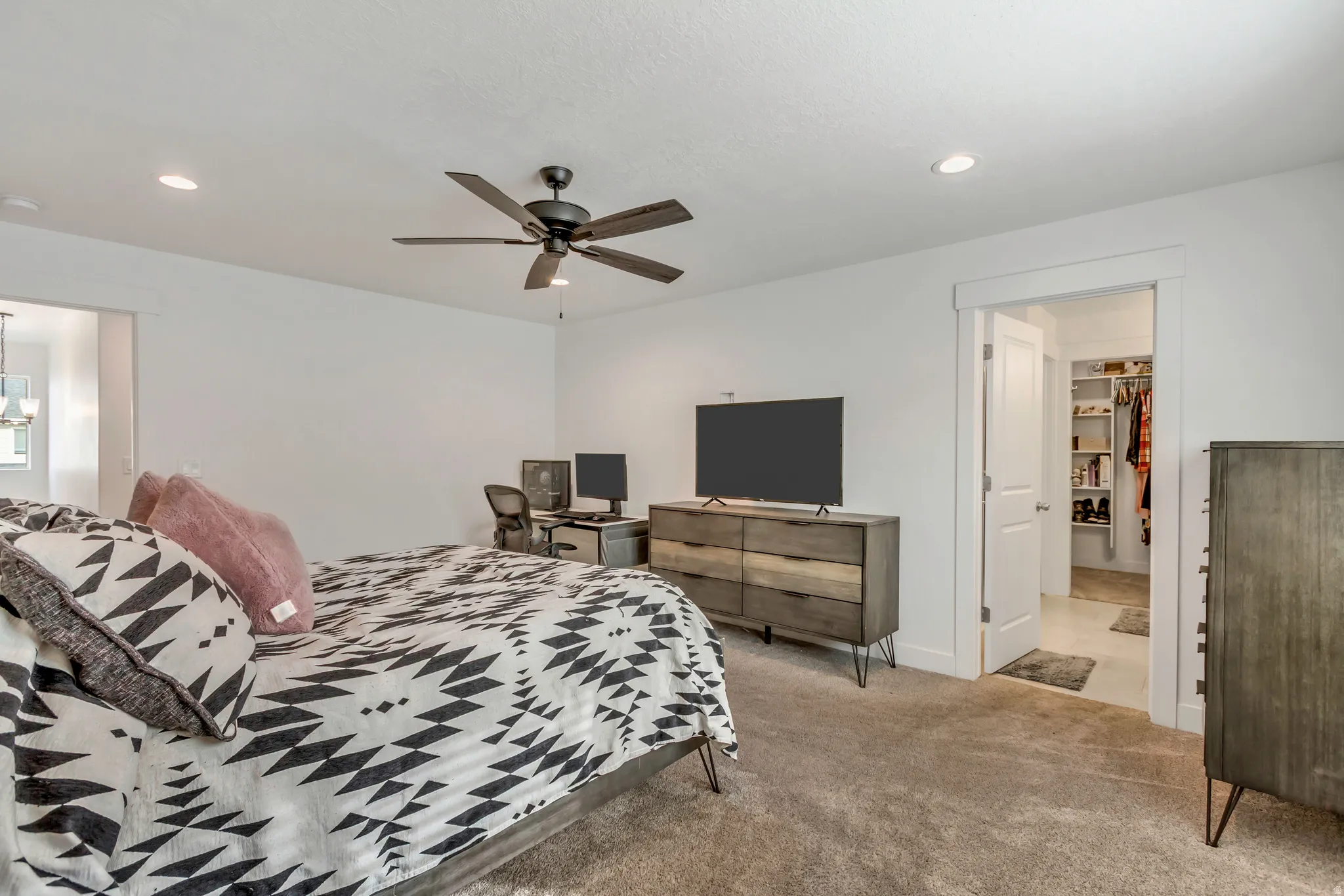 Spacious room featuring neutral carpeting, a ceiling fan with integrated lighting, and recessed ceiling lights
