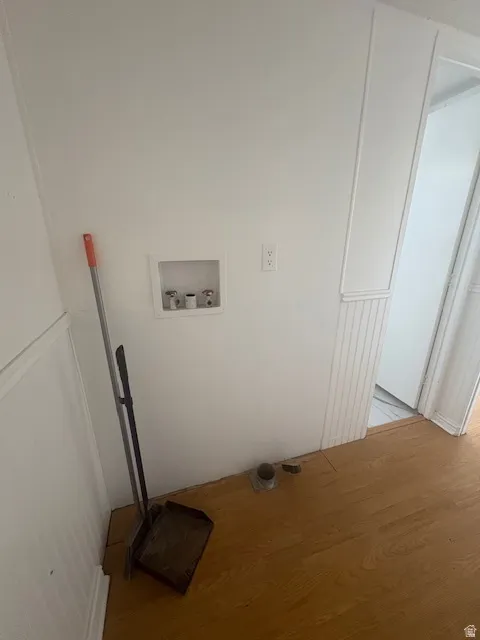 Dedicated utility area featuring a recessed hookup for a washing machine and dryer vent