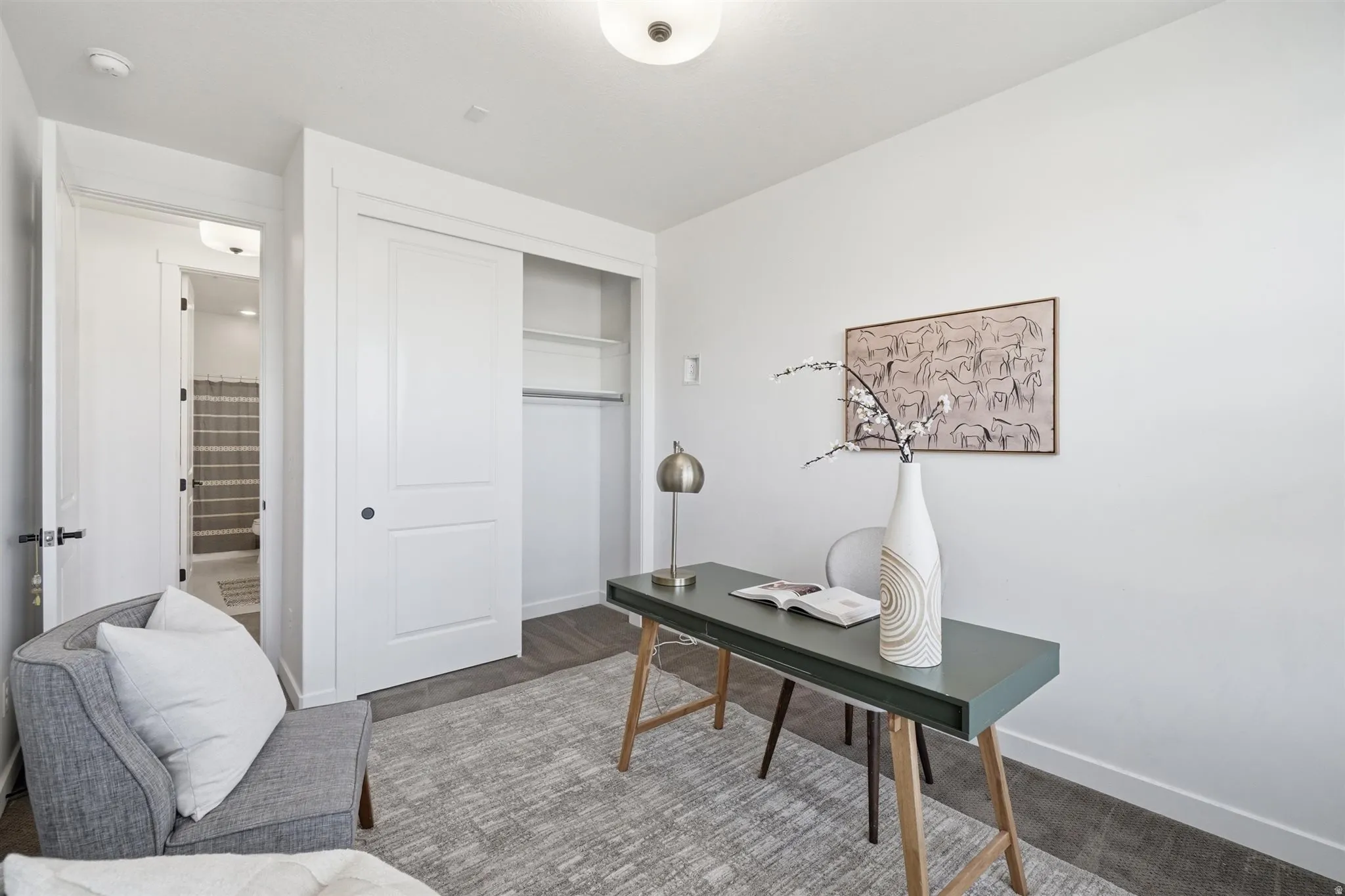 Room featuring light-toned walls and wood-finish flooring