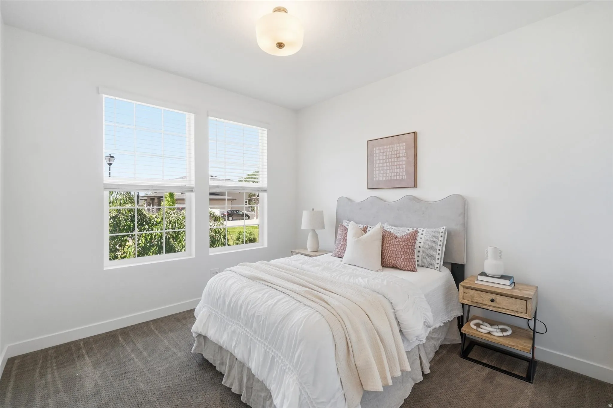 Bedroom featuring neutral carpeting, white walls, and a contemporary ceiling light fixture