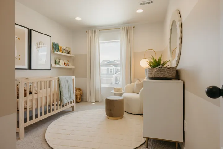 Bright room featuring carpet flooring and a window with white drapes
