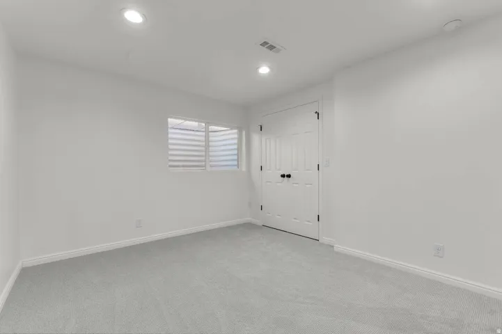 Room featuring light gray carpeting, white walls, and recessed lighting
