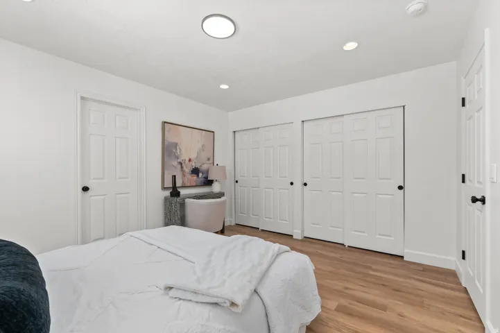 Bedroom featuring wood-finish flooring and bright white walls