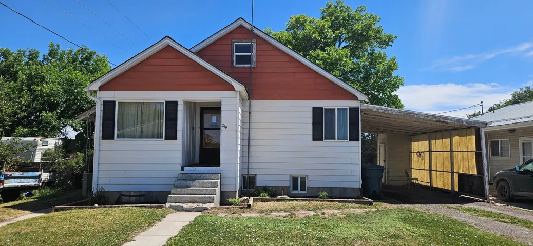 White and orange exterior with a covered front entry