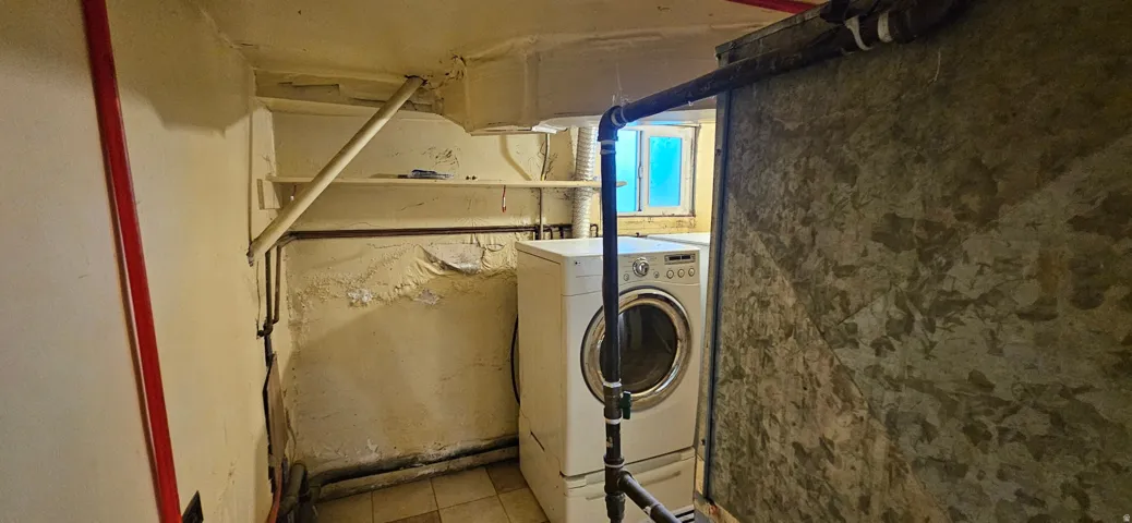 Laundry utility area with a window providing natural light and visible plumbing