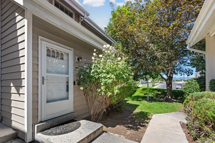 Entryway with a storm door, concrete steps, and vinyl siding
