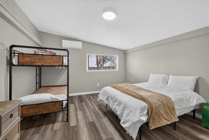 Interior space featuring wood-finish flooring, light gray wall paint, and a white ceiling with a flush-mount light fixture