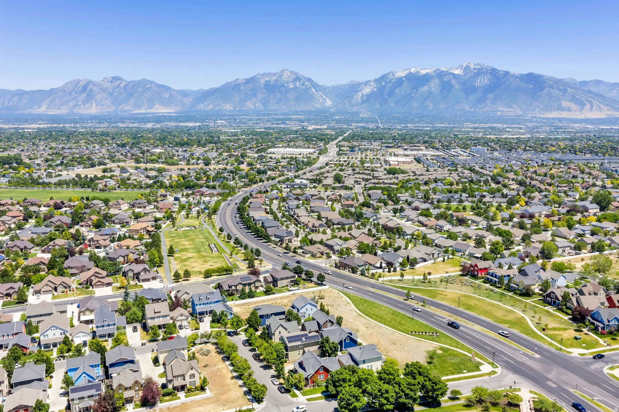 Expansive aerial panorama showcasing a developed residential area with diverse home styles