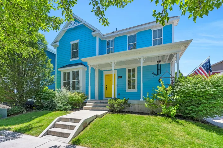 Vibrant blue exterior with a welcoming yellow front door