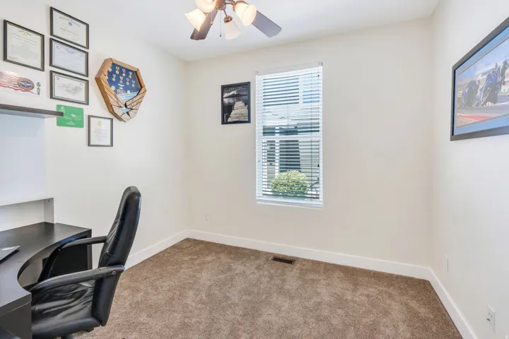 Room featuring a ceiling fan with integrated lighting, carpet flooring, and white baseboards