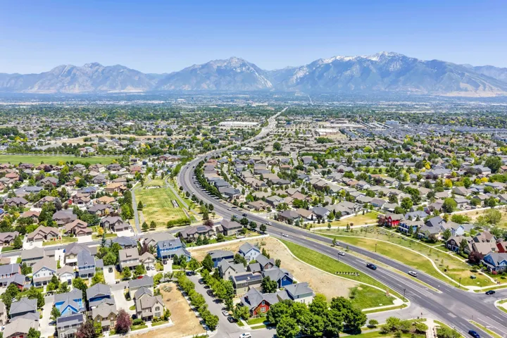 Expansive aerial panorama showcasing a developed residential area with diverse home styles