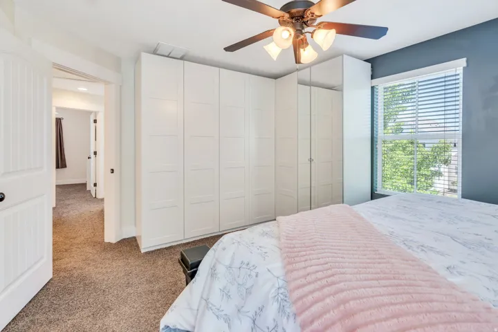 Expansive white built-in cabinetry with mirrored doors provides ample storage