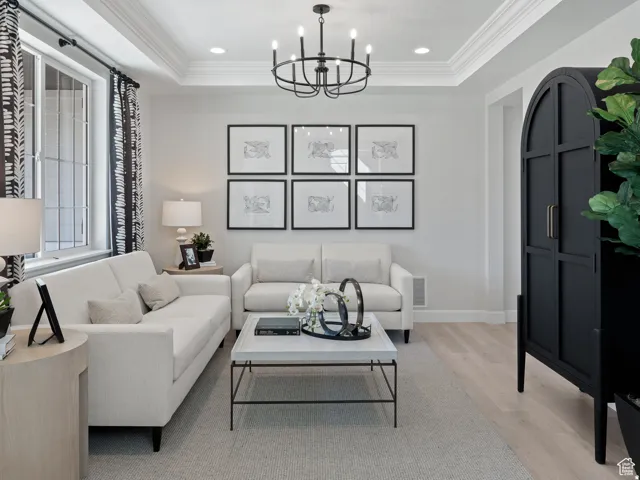 Living space featuring light-colored walls and wood-finish flooring