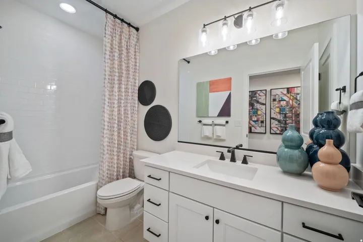 Bathroom featuring a white subway tile surround tub and shower combination