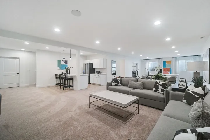 Open-concept living space featuring recessed lighting and light neutral wall colors