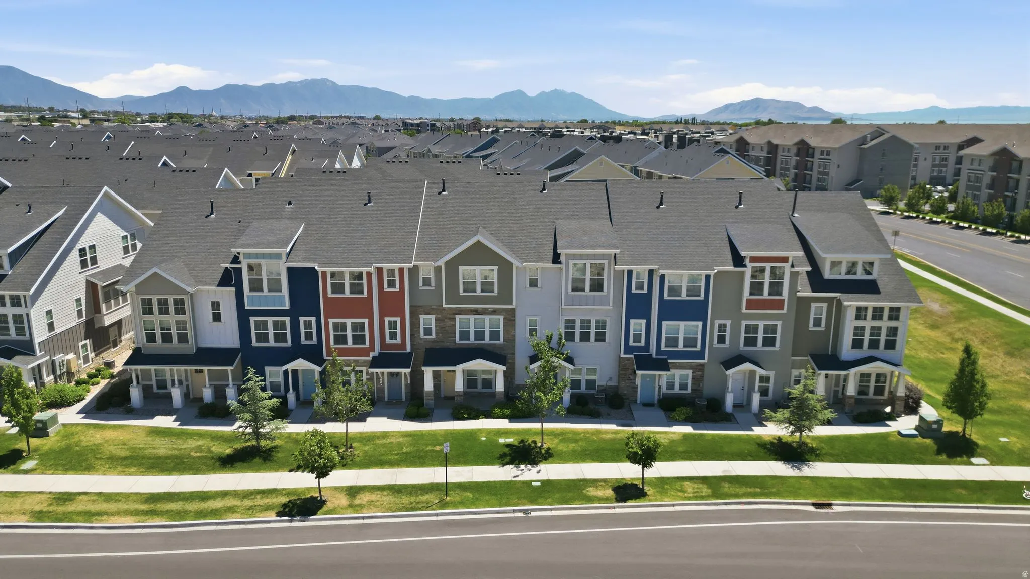 Contemporary townhome-style residences featuring varied facade colors and dormer windows