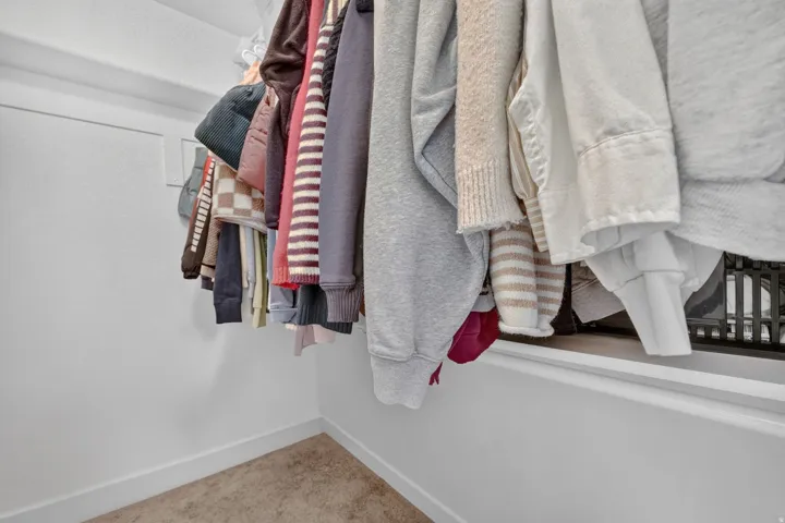 Built-in closet featuring a hanging rod and white shelving