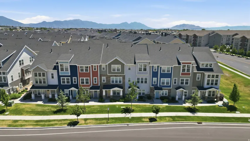 Contemporary townhome-style residences featuring varied facade colors and dormer windows