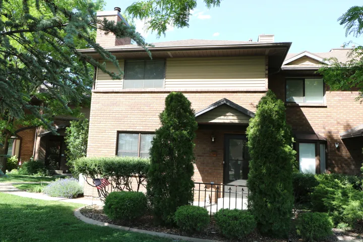 Brick facade with tan siding accents