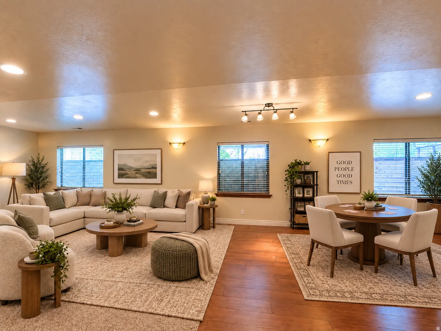 Recessed lighting, warm wall sconces, and multiple windows illuminate the space