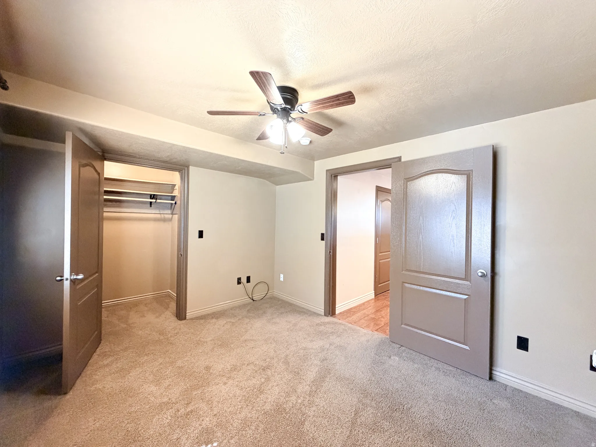 Bedroom 5 Warm-toned carpeting and neutral wall tones